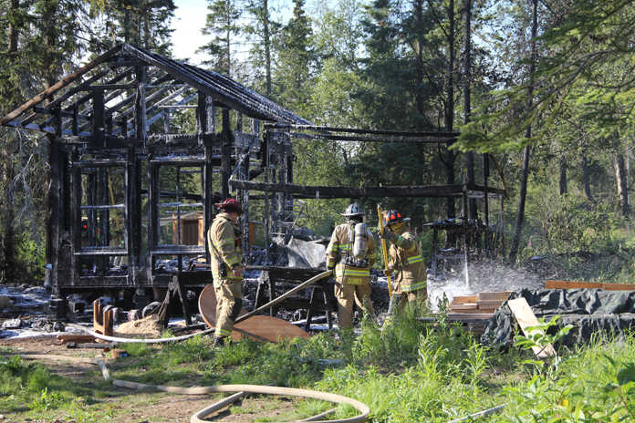 Nikiski Fire Department firefighters continue to work an Aleutian Court home in Nikiski Wednesday after a fire consumed it. When crews arrived at about 6 p.m., Nikiski Fire Department information officer Bud Sexton said the fire had fully involved the home. The sole occupant of the home was out of the structure when crews arrived, and the fire was quickly extinguished, he said. The department responded with one engine, two tankers, one rescue vehicle, one ambulance and about 10 personnel, according to on-scene personnel. The cause of the fire is under investigation. Sexton said he was unable to release the name of the occupant at the time of inquiry. The American Red Cross has been contacted to assist the victim. Photo by Kaylee Osowski/Peninsula Clarion