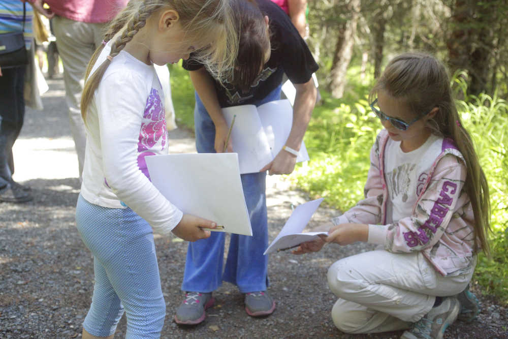 Photo by Kelly Sullivan/ Peninsula Clarion Angela Johnson and Nicole Johnson draw dried mushrooms they found on the ground during their walk in the Family Explorer Program, Saturday, August 2, 2014, on the Keen-Eye Nature Trail in Soldotna.
