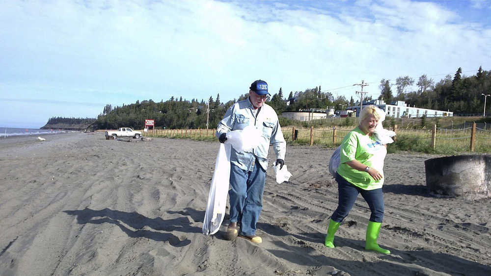 Photo contributed by Rocky Knudsen Rocky Knudsen and Shauna Thornton make their way down the north beach of the Kenai River during a beach clean-up event Friday August 1, 2014 in Kenai, Alaska.