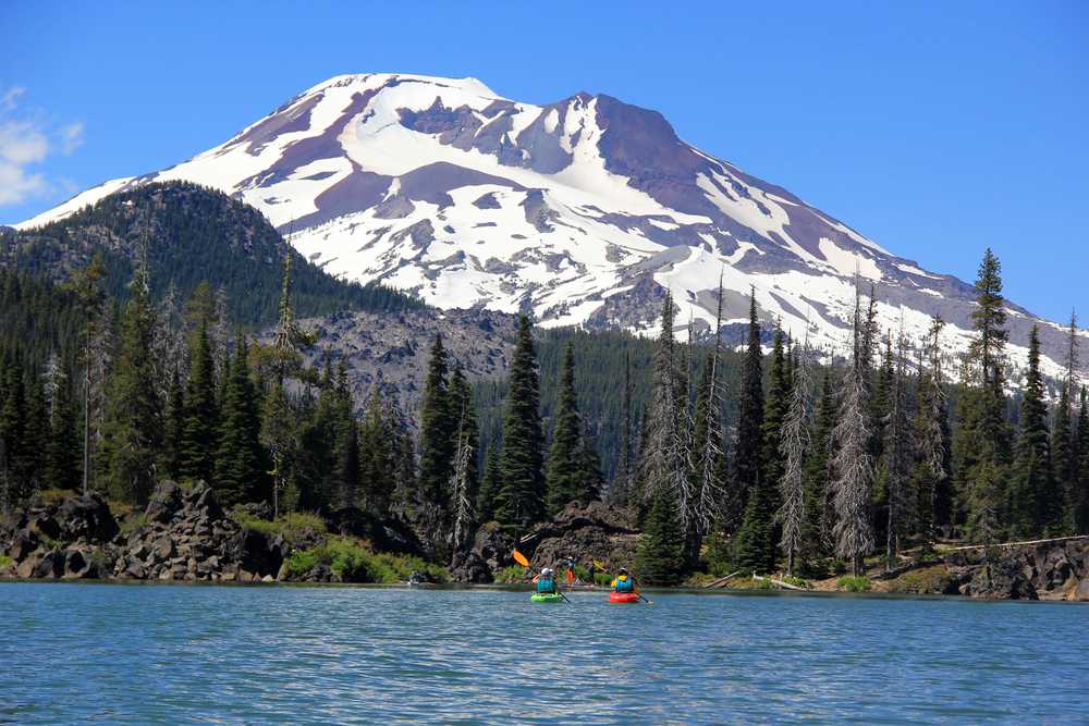 In this photo taken on June 29, 2014, South Sister rises high above the Sparks Lake, a popular place for canoeing and kayaking, in the central Cascades in Deschutes County,  about 35 miles west of Bend, Ore. (AP Photo/Statesman-Journal, Zach Urness)