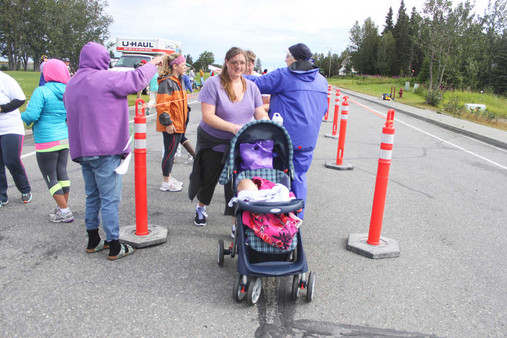 Photo by Kelly Sullivan/ Peninsula Clarion Michelle Teates pushed her 5-month-old daughter Hazel Teates for the entire Women's Run 10k, Saturday, August 9, 2014, at the Kenai Park Strip, Kenai, Alaska.
