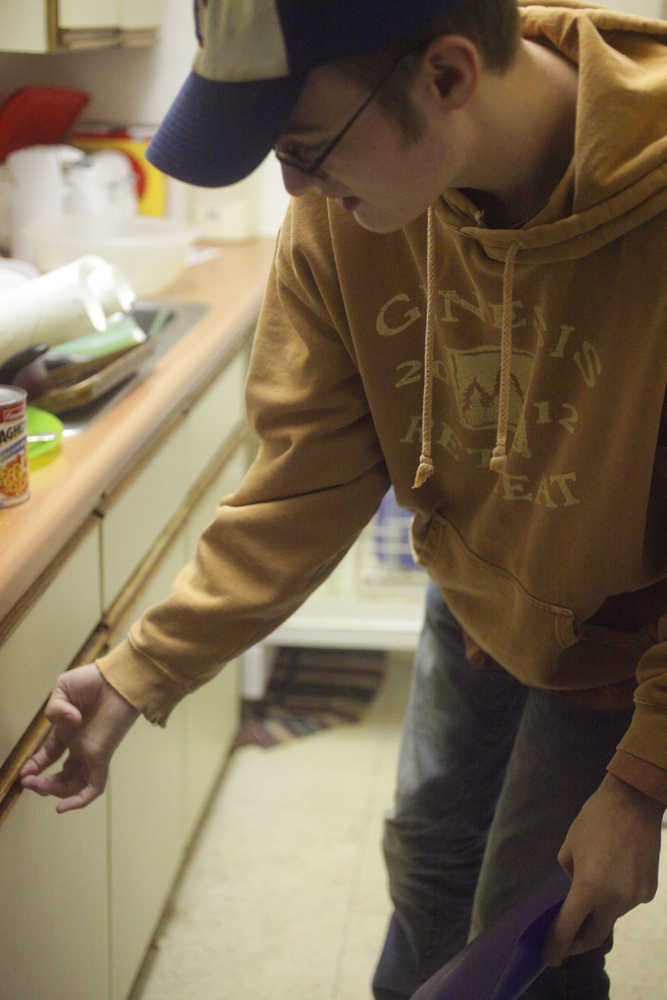 Photo by Kelly Sullivan/ Peninsula Clarion Preston Bicknell works on the dishes at mothers house, Saturday, August 9, 2014, in Soldotna, Alaska. His mother Traci Bicknell said it is a chore he is having trouble learning.