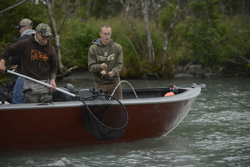 A guide waits to net a pink salmon caught by a member of military who spent two days fishing on the Kenai River Friday August 8, 2014 near Soldotna, Alaska. The Kenai River Foundation hosted the "Wounded Heroes" fishing event that brought more than 70 military members down to the Kenai River and paired them up with area guides who took them fishing August 8-9. Photo by Rashah McChesney/Peninsula Clarion