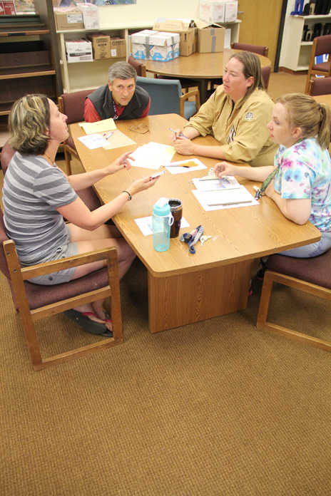 A group of Soldotna Prep teachers collaborate on Friday. Photo by Kaylee Osowski/Peninsula Clarion
