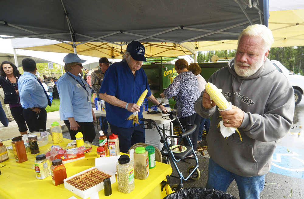 Photo by Kelly Sullivan/ Peninsula Clarion Community member Andy Paule prepares a corn husk during the Kenai Peninsula Borough, Kenai Peninsula College alumni and Kenai Peninsula Borough School District joint 50th anniversary community barbecue, Thursday, August 14, at the KPC Kenai River Campus in Soldotna, Alaska.