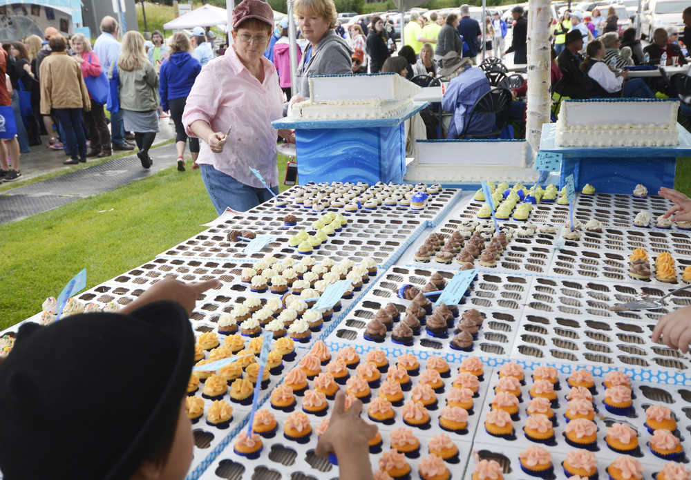 Photo by Kelly Sullivan/ Peninsula Clarion Karen Otter made 800 mini-cupcakes for the the Kenai Peninsula Borough, Kenai Peninsula College alumni and Kenai Peninsula Borough School District joint 50th anniversary community barbecue, Thursday, August 14, at the KPC Kenai River Campus in Soldotna, Alaska.