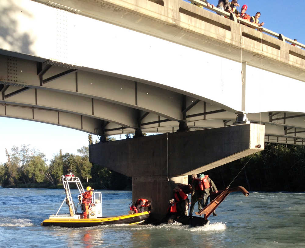 Photo courtesy Central Emergency Services Responders rescue four men from the Kasilof River after a current overturned their boat shortly after they launched into the river Monday morning under the Kasilof Bridge of the Sterling Highway.