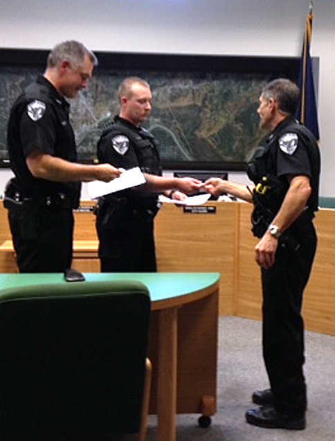 Photo courtesy Shellie Saner, Soldotna city clerk Soldotna Police Chief Peter Mlynarik presents medals to Officers Derek Urban and Stephen Clary for saving a man's life at the Aug. 13 Soldotna City Council meeting. Mlynarik thanked the officers for their actions in rescuing the man from the Kenai River on June 24.