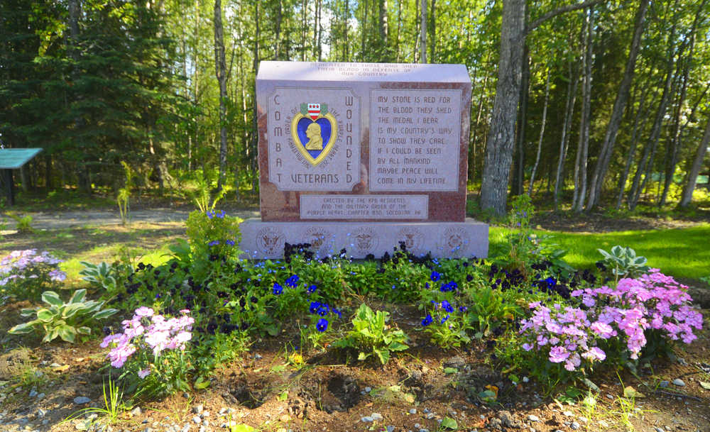 Photo by Kelly Sullivan/ Peninsula Clarion Deep holes were left when theives stole flowers from the Purple Heart memorial at Soldotna Creek Park Tuesday last weekend, August 19, 2014, in Soldotna, Alaska.