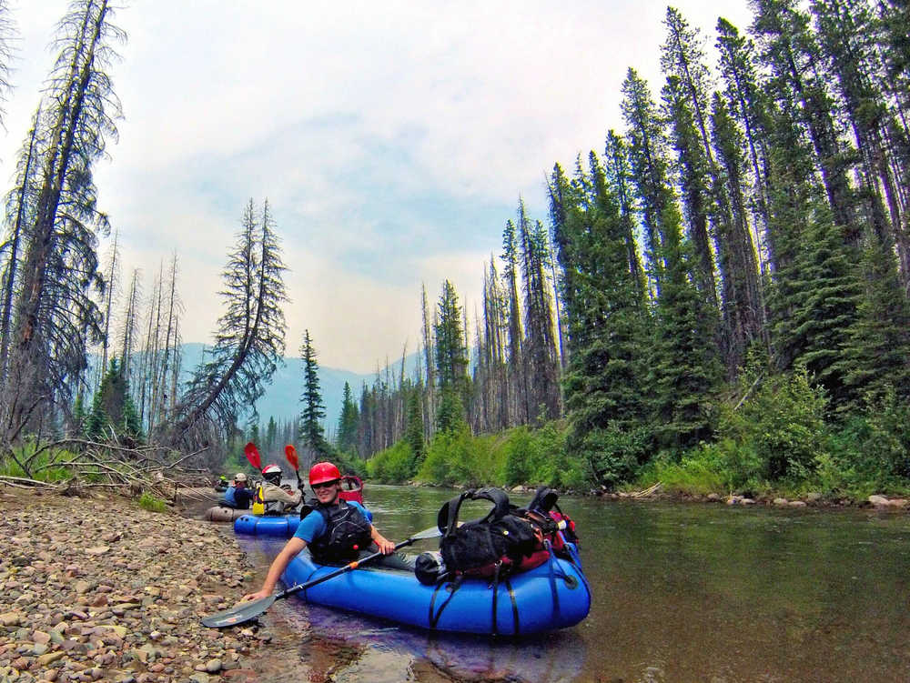 Jared White paddles his packraft through a rapid on the South Fork Flathead River, in Mont. Packrafts allows adventurers to float wilderness rivers without needing a pack string to carry a full-sized raft, said Jared White, the Wilderness Society's regional communications manager in Bozeman. (AP Photo/The Great Falls Tribune, Erin Madison)  NO SALES