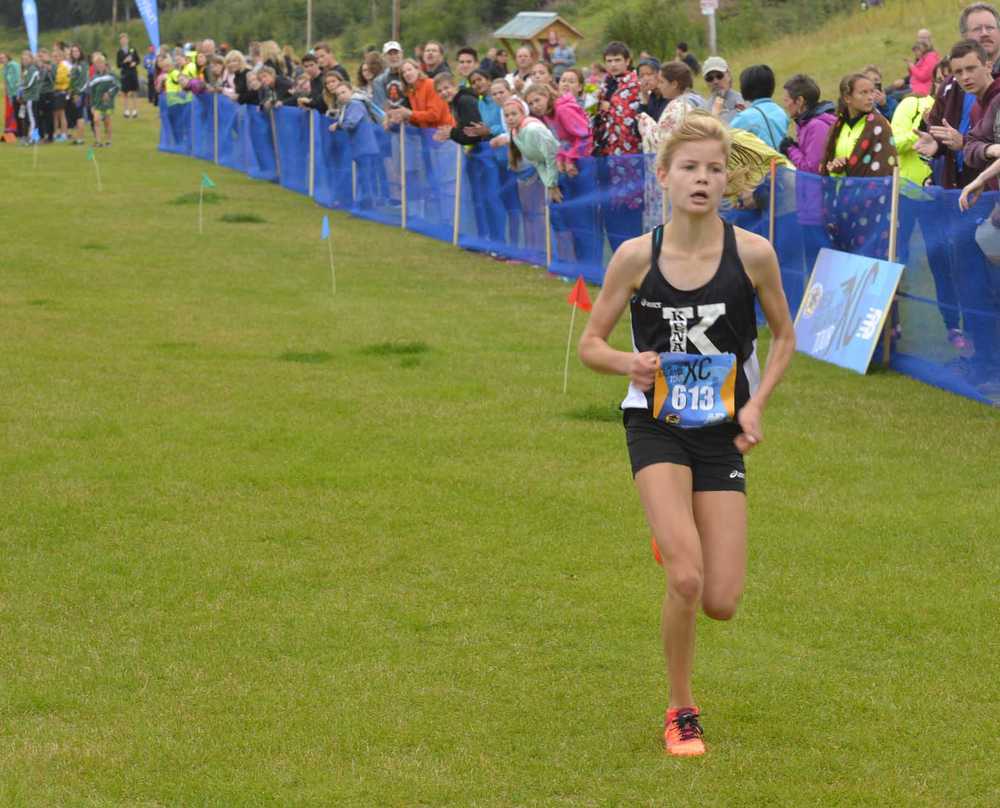 Photo by Jeff Helminiak Kenai Central senior Allie Ostrander finishes off a dominant win Saturday at the Tsalteshi Invitational at Tsalteshi Trails. Ostrander finished in 16 minutes, 44 seconds, to beat everybody else by more than two minutes.