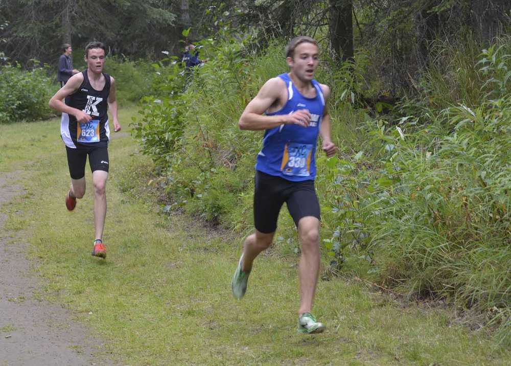 Photo by Jeff Helminiak Kenai Central's Jonah Theisen tries to hand on to Chugiak's Ty Jordan less than a kilometer from the finish Saturday at the Tsalteshi Invite at Tsalteshi Trails. Jordan would take second, while Theisen would be three seconds behind in third.