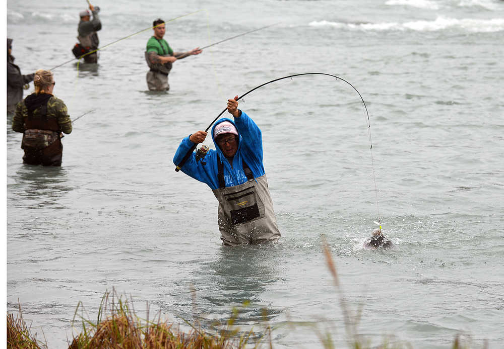 Photo by Dan Balmer/Peninsula Clarion Fish On Wasilla resident Tina Clifford pulls up a pink salmon from the Kenai River at Swiftwater Creek Campground Sunday. Clifford, who is on a 10-day camping trip with friends, said she has also caught and released a couple silver salmon.