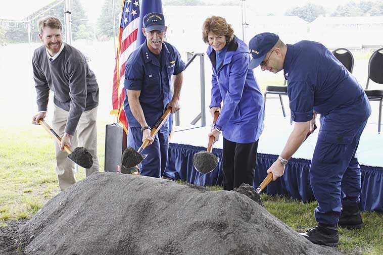 ADVANCE FOR USE MONDAY, AUG. 25 - This Aug. 14, 2014 photo shows from left, housing project manager Lars Wagner, Vice Admiral Charles Ray, commander of the Coast Guard Pacific Area, U.S. Sen. Lisa Murkowski and Capt. Jeffrey Westling, commander of Coast Guard Base Kodiak, scooping up gravel at the groundbreaking ceremony for a new Coast Guard Base Kodiak housing facility in Kodiak, Alaska. The housing facility is expected to be completed in 2016. (AP Photo/Kodiak Daily Mirror, Julie Herrmann)