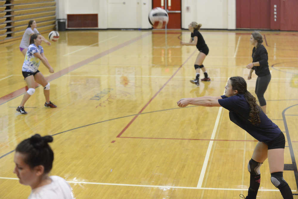 Kelly Sullivan/ Peninsula Clarion Becky Dragseth spikes the ball, Thursday, August 29, 2014, during the Kenai Central High School girls varsity volley ball practice, at Kenai Central High School, in Kenai, Alaska.