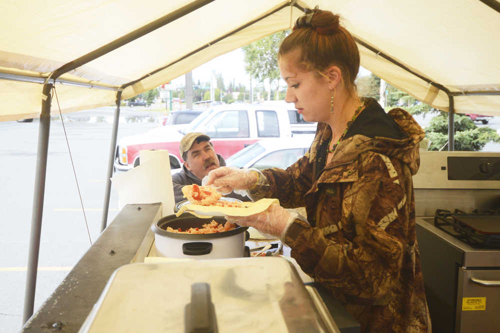 Photo by Kelly Sullivan/ Peninsula Clarion Kim Goggia and Mario Gomez made their first trip to the Wook Waffaz Waffle Emporium food truck, Friday, August 29, 2014 in Soldotna, Alaska.
