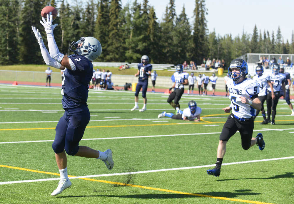 Photo by Kelly Sullivan/ Peninsula Clarion Soldotna High School's Bailey Blumentritt catches a pass, Saturday, August 30, 2014 during the varsity game against Thunder Mountain high school at Soldotna High School in Soldotna, Alaska.