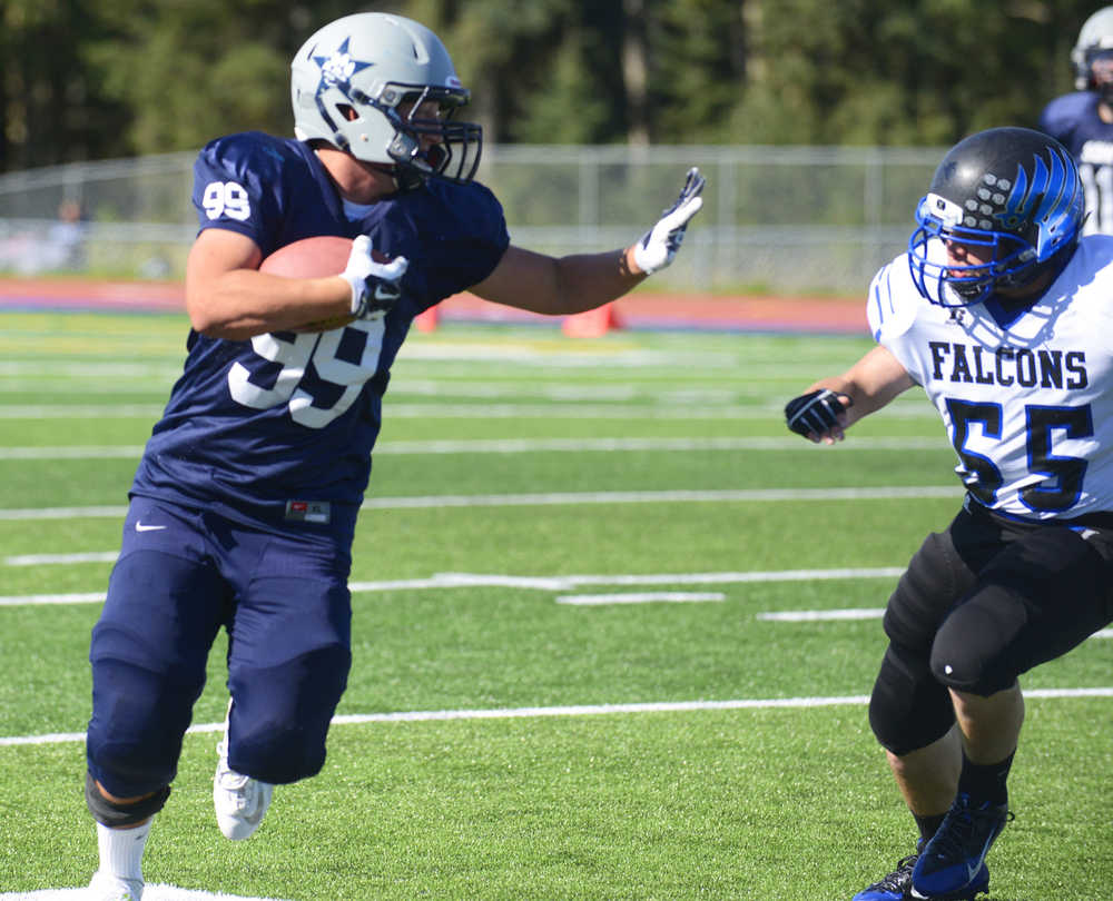 Photo by Kelly Sullivan/ Peninsula Clarion Soldotna High School's Trevor Walden tries to avoid an intercept from Jase Lippert, Saturday, August 30, 2014 during the varsity game against Thunder Mountain high school at Soldotna High School in Soldotna, Alaska.