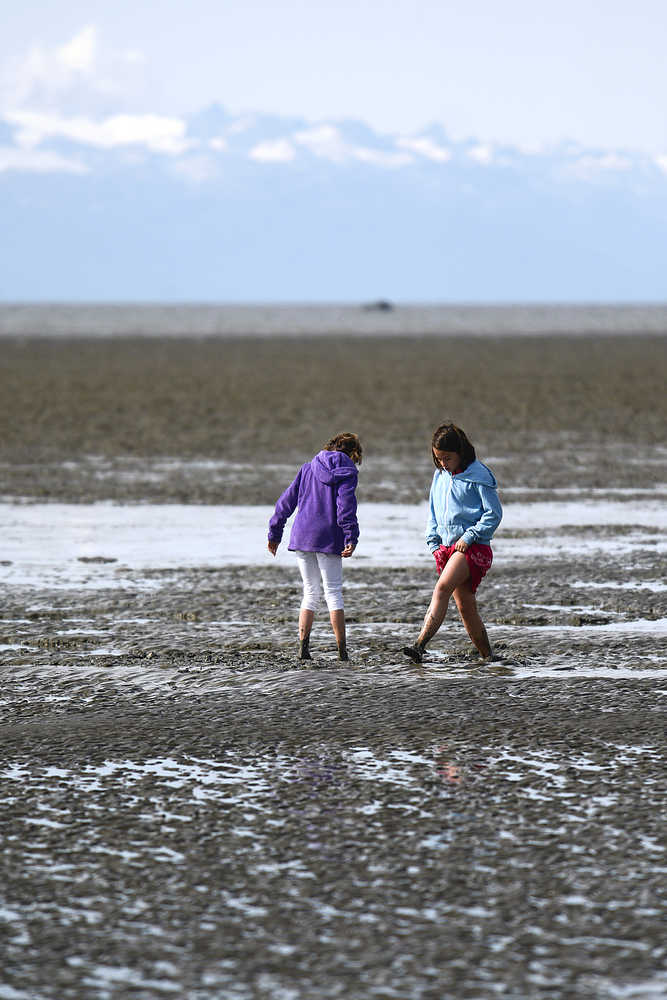 Photo by Rashah McChesney/Peninsula Clarion Shannon Pitt, of Nikiski and Jenna Streiff, of Kenai, play in the mud during low tide in the Cook Inlet Sunday August 31, 2014 in Kenai, Alaska.
