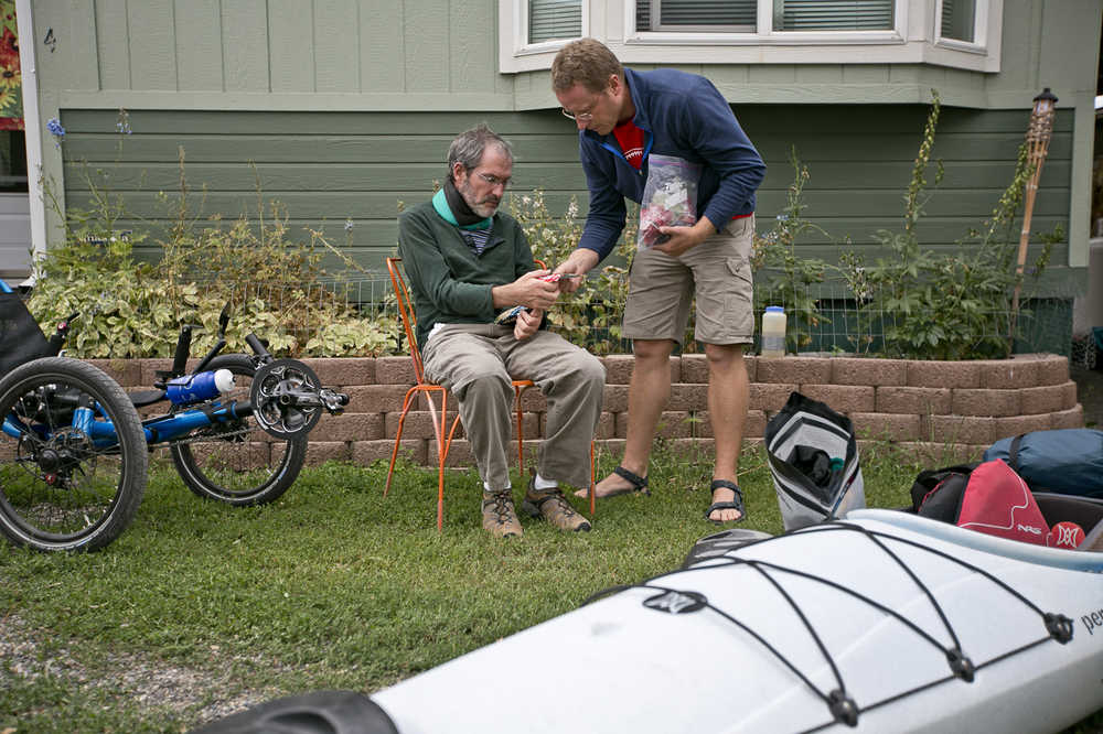 Mike Yochim, 47, a National Parks Service planner, left, helps his friend Eric Compas decide on the meals to carry for a canoe trip on Thursday, Aug. 20, 2014, in Gardiner, Mont. Yochim was diagnosed with Amyotrophic lateral sclerosis (ALS) in September 2013 and will be joined by three of his closest friends for one last wilderness trip around Yellowstone Lake. (AP Photo/Bozeman Daily Chronicle, Adrian Sanchez-Gonzalez)