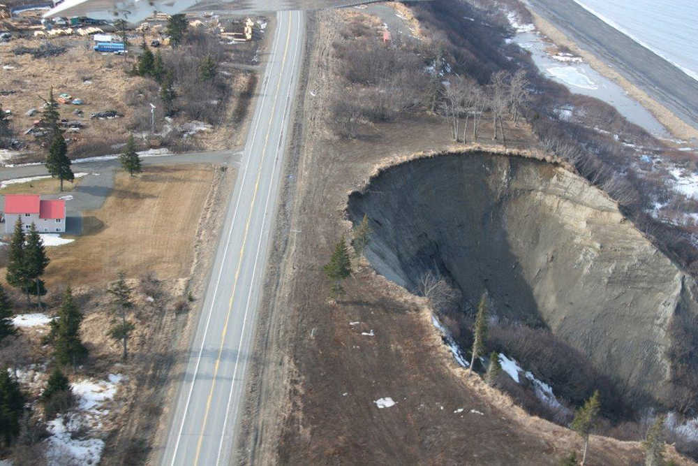 The edge of the bluff encroaches on the Sterling Highway at Milepost 153.3. The edge is within 50 feet of the highway. Photo provided by the Alaska Department of Transportation and Public Facilities