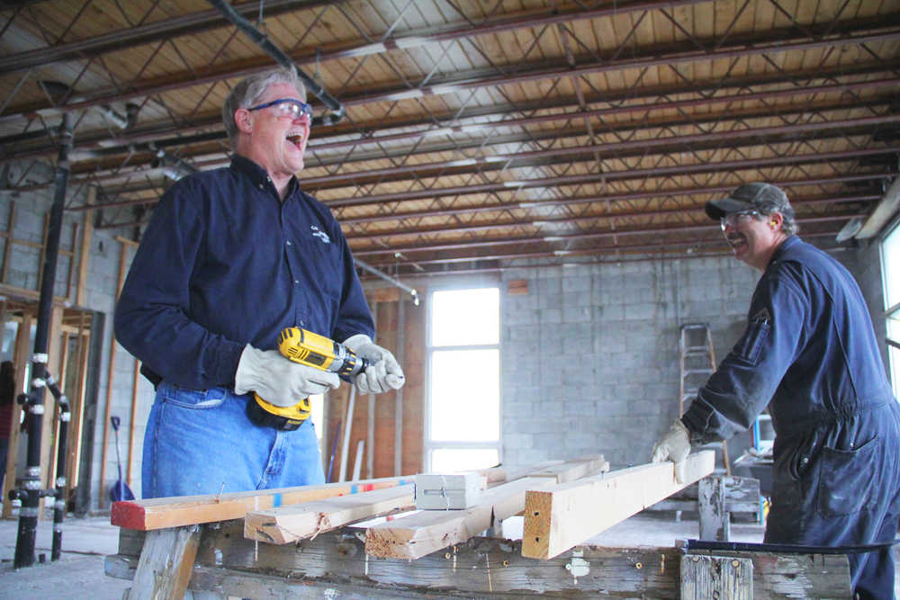 Photo by Kelly Sullivan/ Peninsula Clarion ConocoPhillips employees Dave Knudsen and Dean Hatch work on salvaging building frame boards. The wood will be recycled and used the ABC Pregnancy Care Center's new location on Frontage Road where they will move into in May 2015, Tuesday, September 9, 2014, in Kenai, Alaska.