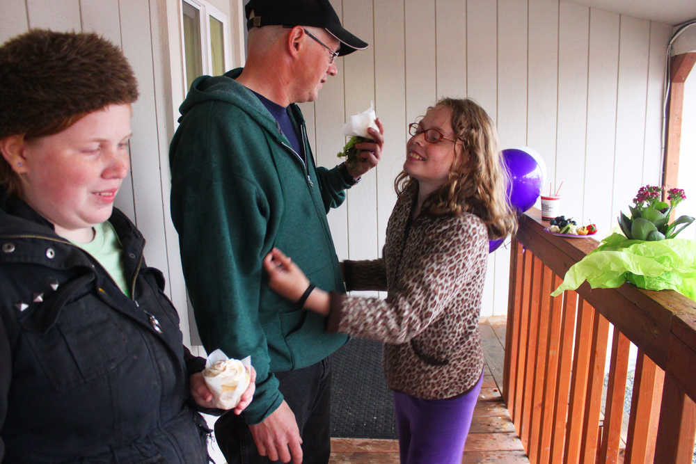 Photo by Kelly Sullivan/ Peninsula Clarion Mercedes Norris, Dustin Norris and Venice Norris came to the groundbreaking party for HOPE Community Resources Inc.'s new community recreation center on Tuesday, September 09, 2014, in Soldotna, Alaska. Dustin Norris helped pour the center's foundation and Mercedes Norris choses to use HOPE's resources.