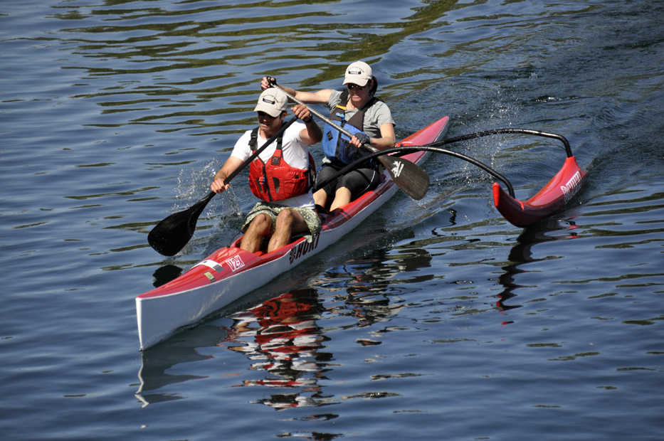 ADVANCE FOR WEEKEND EDITIONS SEPT. 6-7 - In this Aug. 23, 2014 photo, Brook and Lisa Swanson are in perfect synch as they paddle their racing canoe in the Spokane River Classic in Spokane, Wash. (AP Photo/The Spokesman-Review, Rich Landers)  COEUR D'ALENE PRESS OUT