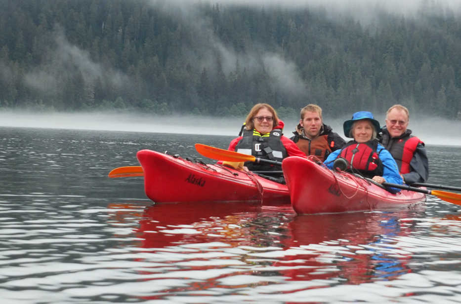 In this July, 2013, photo, from left, Robin Hanley, Bjorn Dihle, Lynnette Dihle and Nils Dihle watch bears on the shore of Middle Creek on Admiralty Island near Windfall Harbor, Alaska.  The area around Pack Creek, a bear-viewing area on Admiralty Island, offers some amazing sights not too far from Juneau, Alaska.(AP Photo/Juneau Empire, Mary Catharine Martin)