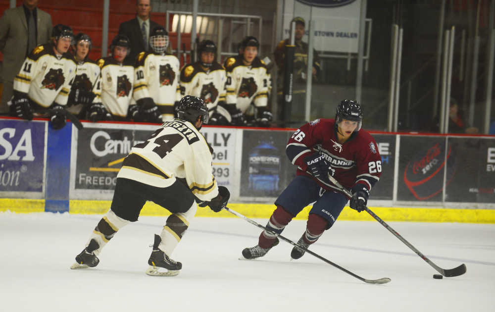 Photo by Kelly Sullivan/ Peninsula Clarion Kenai Brown Bears' Collin Charyszyn and Fairbanks Ice Dogs' Jacob Hetz go for the puck, Friday, September 12, 2014, at the Soldotna Regional Sports Complex in Soldotna, Alaska.