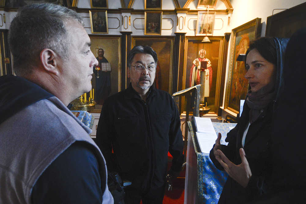 Photo by Rashah McChesney/Peninsula Clarion (left) Evgeny Demidov, of Sakhalin, listens to Father Thomas Andrew, of Kenai, as Leila Loder, of Oregon, translates during a visit to the Holy Assumption of Mary Russian Orthodox Church Thursday September 11, 2014 in old town Kenai, Alaska.