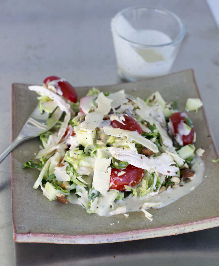 This Sept. 15, 2014 photo shows Brussels sprouts and chicken salad with mustard pepper dressing in Concord, N.H. Brussels sprouts belong to the same family as cabbage, broccoli and kale, so it's no surprise that they are incredibly healthy. (AP Photo/Matthew Mead)