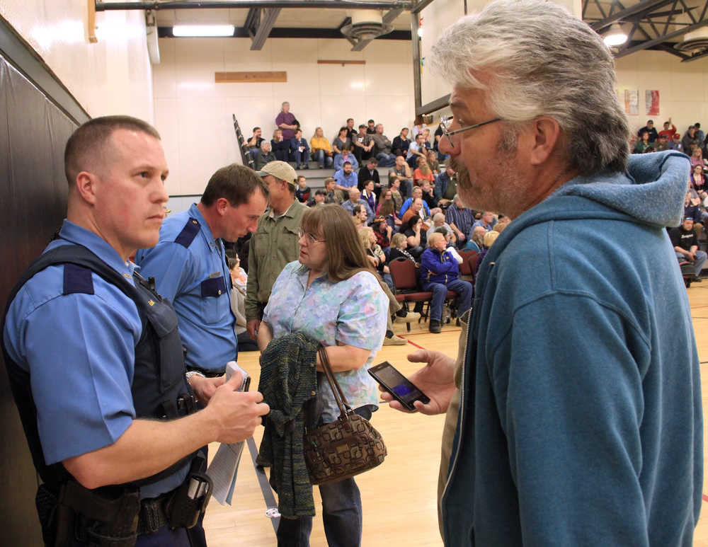 Photo by Dan Balmer/Peninsula Clarion Nikiski resident Dennis Barnett shares information with Alaska State Trooper Matt Ezell at a town hall meeting at the Nikiski Recreation Center Wednesday. Residents gathered to search for answers to a rash of thefts that has affected the community.