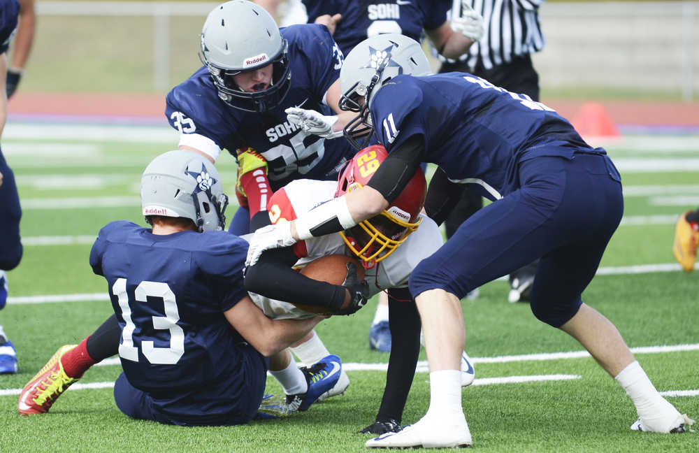 Photo by Kelly Sullivan/ Peninsula Clarion The Soldotna Stars bring down Faribanks' West Valley Wolf Pack's Joshua Cummings, Saturday, September 27, 2014 at Soldotna High School in Soldotna, Alaska.