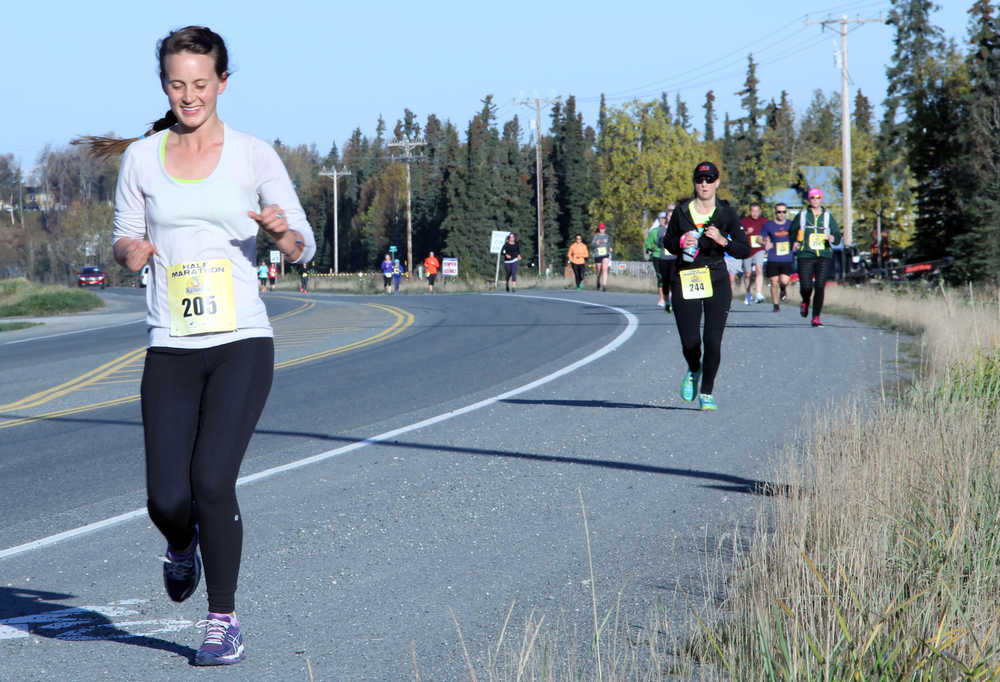 Hannah Wagner, of Anchorage, leads a group of half marathon runners on Bridge Access Road in Kenai during the Kenai River Marathon on Sunday. Photo by Kaylee Osowski/Peninsula Clarion