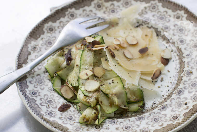 This Sept. 8, 2014 photo shows grilled zucchini ribbons with Parmesan and toasted almonds in Concord, N.H.  The grilled zucchini ribbons add both flavor and visual appeal to many dishes. (AP Photo/Matthew Mead)