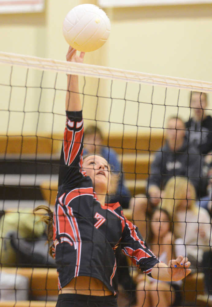 Photo by Kelly Sullivan/ Peninsula Clarion Kenai Kardinals' Cierra King spikes the ball at the net during a game against the Cordova Wolverines, Thursday, October 2, 2014, at Kenai Central High School in Kenai, Alaska.