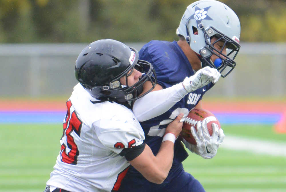 Photo by Kelly Sullivan/ Peninsula Clarion Kenai Kardinals' Chase Logan tackles Soldotna Stars' Drew Gibbs, Saturday, October 4, 2014, at Soldotna High School in Soldotna, Alaska.