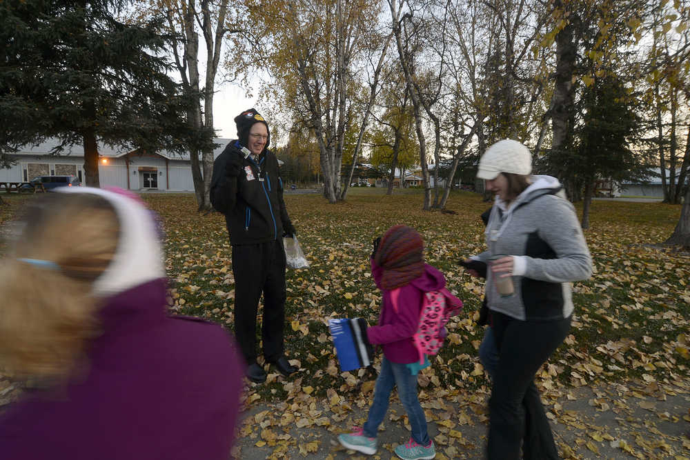 Photo by Rashah McChesney/Peninsula Clarion  Redoubt Elementary school Principal John Pothast greets students as they walk to school during Walk Your Kids to School Day Wednesday October 1, 2014 in Soldotna, Alaska.