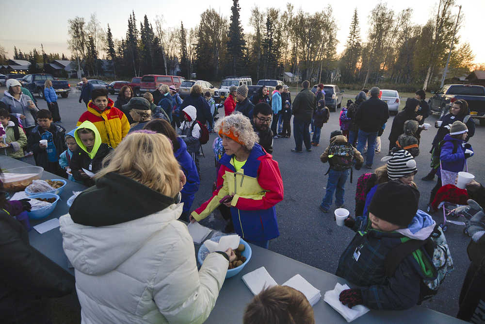 Photo by Rashah McChesney/Peninsula Clarion  More than 150 people gathered in a parking lot for snacks and prizes before the annual  Walk Your Kids to School Day Wednesday October 1, 2014 in Soldotna, Alaska.