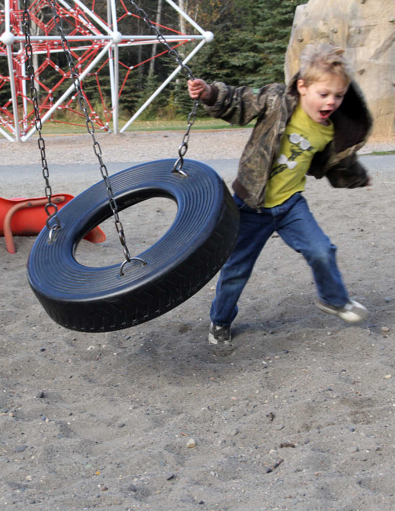Caleb Mills, 5, plays on the tire swing at Kenai Municipal Park on Sunday. Photo by Kaylee Osowski/Peninsula Clarion