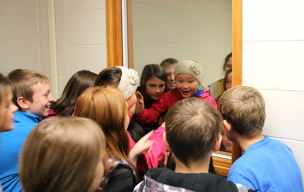 Photo by Dan Balmer/Peninsula Clarion Fifth-grade students from Cindy Hurst's Kaleidoscope School of Arts and Science class look through the glass in the interrogation room during a tour of the Kenai Police Department Monday. During the field trip, three classes also participated in a mock city council meeting at Kenai City Hall and a mock trial at Kenai Youth Court to learn about the three branches of government.