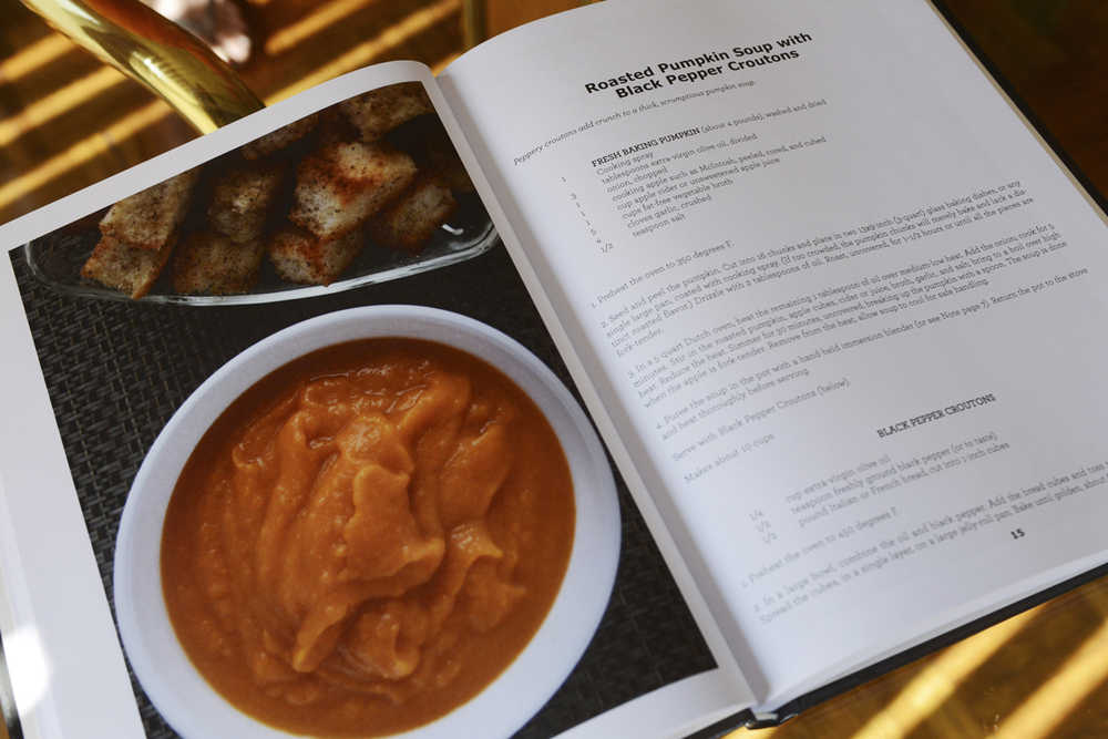 In this Sept. 19, 2014 photo, a recipe for roasted pumpkin soup with black pepper croutons is seen in the cookbook "For the Love of Pumpkins' by author Marilyn Alice Tuckman at her home in Elk Grove Village, Ill. It is one of the 100 gourd recipes in the book. (AP Photo/Daily Herald, Joe Lewnard)  MANDATORY CREDIT, MAGS OUT