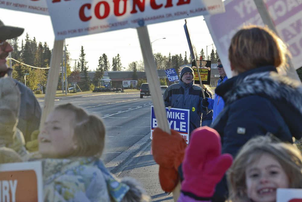 Photo by Rashah McChesney/Peninsula Clarion Kenai City Council candidate Mike Boyle chats with others standing along the Kenai Spur Highway - each holding signs for their favorite candidates in the borough-wide elections Tuesday October 7, 2015 in Kenai, Alaska.