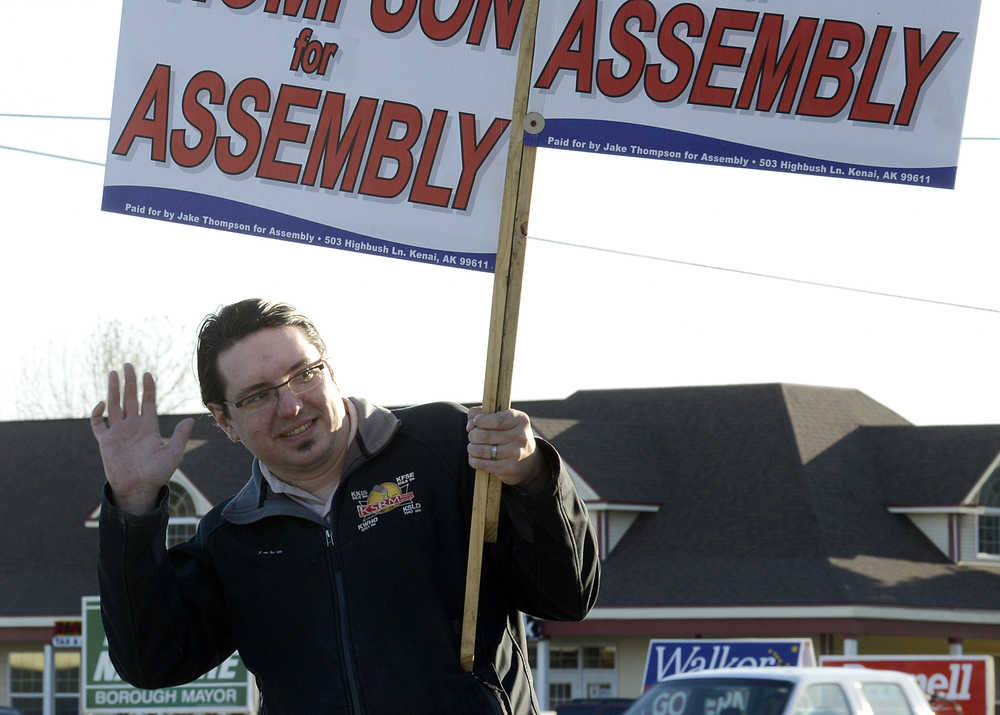 Photo by Rashah McChesney/Peninsula Clarion Jake Thompson, candidate for the Kenai Peninsula Borough assembly, waves to passersby at the corner of the Kenai Spur Highway and the Main Street Loop Oct. 1, 2014 in Kenai, Alaska. Thompson lost his bid for the seat.