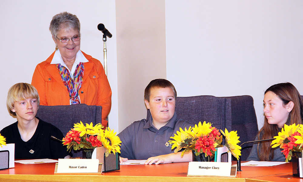 Photo by Dan Balmer/ Peninsula Clarion Kenai Mayor Pat Porter watches as Kaleidoscope students Issac Erwin, Caden Fields and Cloey Followell from Julie Stephen's fifth and sixth grade class participate in a mock city council meeting Monday, Oct. 6, 2014 at Kenai City Hall.