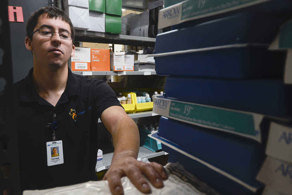 Photo by Rashah Mcchesney/Peninsula Clarion  Forrest Henry walks through gives a tour of a supply room at Thursday October 9, 2014, where he works as an intern through the Project SEARCH program at Central Peninsula Hospital in Soldotna, Alaska.