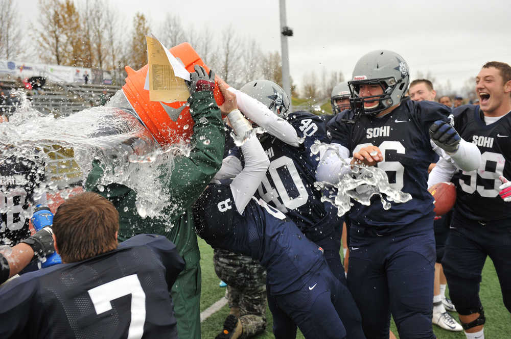 SoHi defensive coordinator Eric Pomerlau is doused by happy Stars players, from left, Ty Fenont (7), Jared Chavez (8), Brenner Furlong (40) and Dalton Best (66).