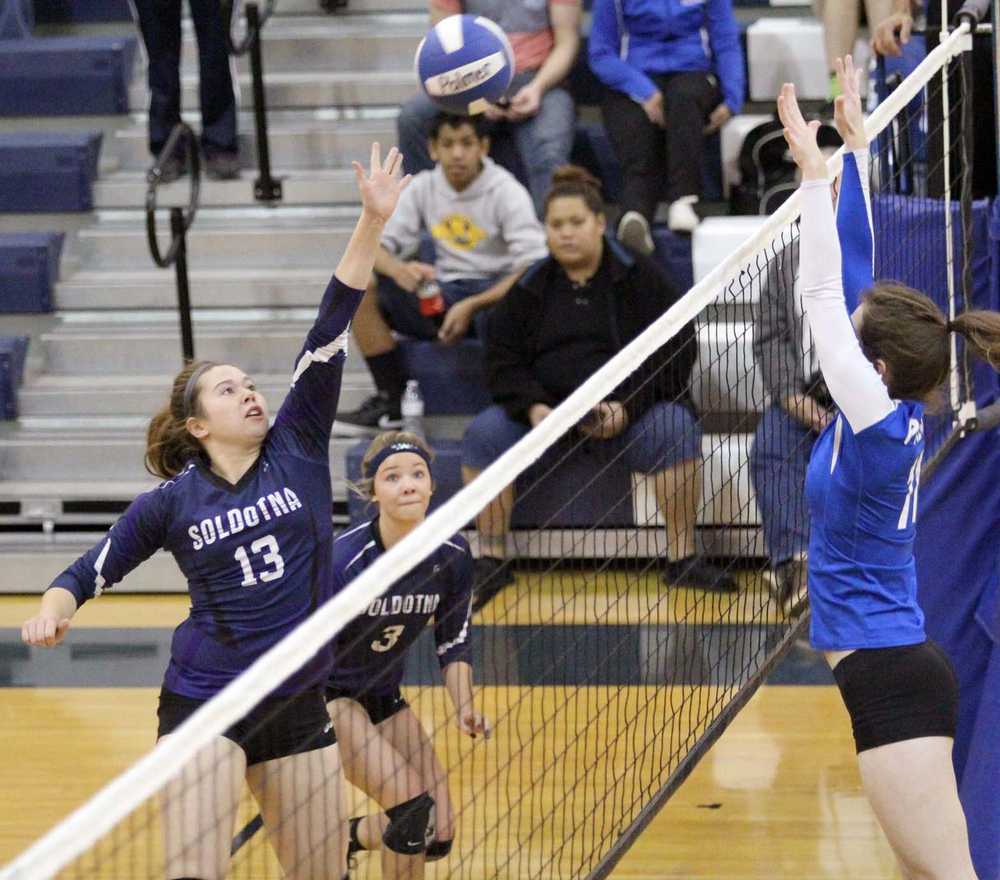 Soldotna's Haley Miller tries to tip the ball past the Palmer block during a 3-2 loss to the Moose Oct. 11 at Palmer High School.