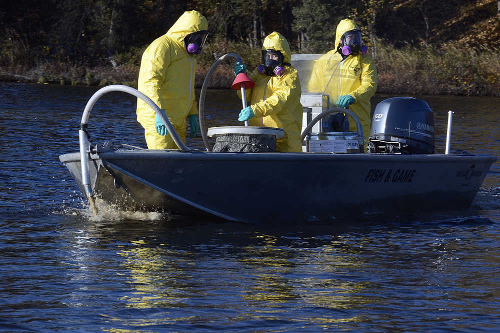 Photo by Rashah McChesney/Peninsula Clarion  Several agencies teamed up with the Alaska Department of Fish and Game as it treated four lakes in the Soldotna Creek drainage during the second week of October. Here, researchers mix the fish-killing rotenone before it is pumped into East Mackey Lake on Wednesday October 8, 2014 in Soldotna, Alaska.